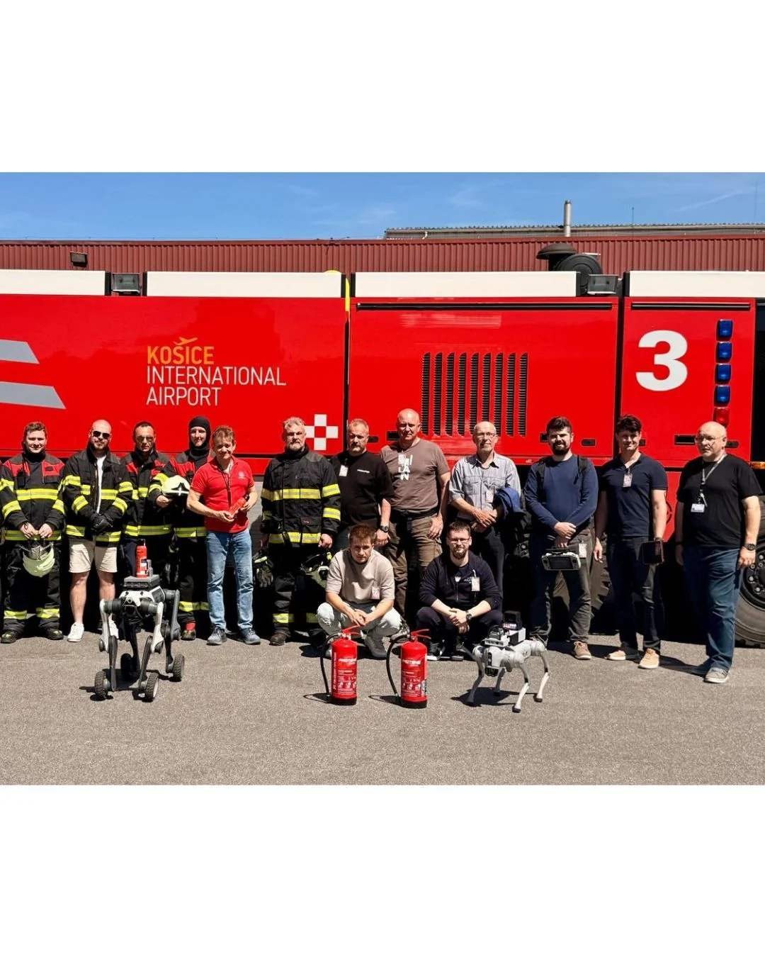 Invelogy team and airport firefighters together in front of a fire engine at Košice Airport